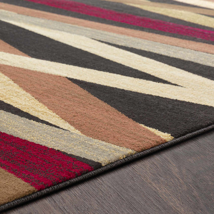 Close-up of Brevard Striped Area Rug showing beige, brown, red, and gray stripes on a dark wood floor. Contemporary style. Texture