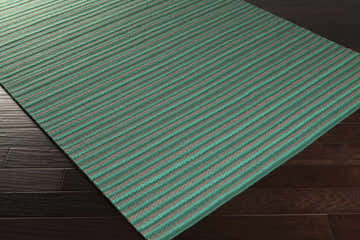 Close-up of the hand woven Bergheim Area Rug. Aqua and medium gray stripes on a wool rug. Farmhouse style. Corner