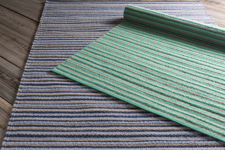 Close-up of the hand woven Bergheim Area Rug. Aqua, medium gray, and seafoam stripes on a wool runner. Styleshot