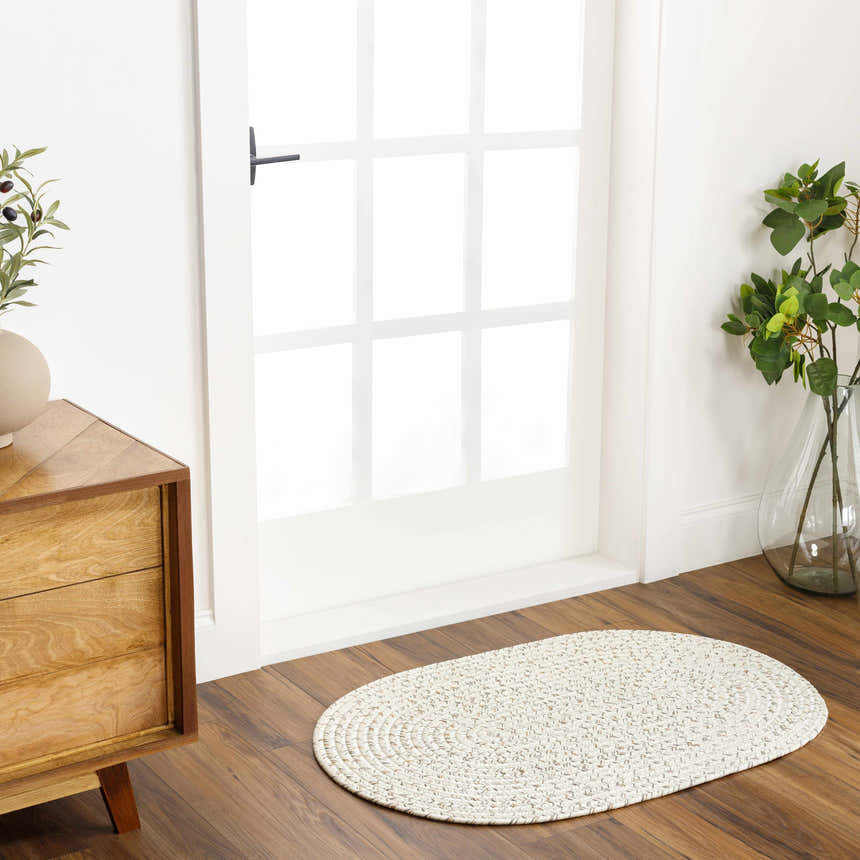 Entryway with wood floors, oval Beige Braided Faux Jute Rug, wood cabinet, and white door. Farmhouse style. Roomscene-Oval