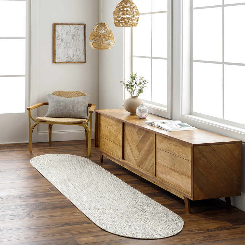 Entryway with a Beige Braided Faux Jute Rug, wood console table, woven pendant lights, and a chair with a gray pillow. Roomscene-Runner