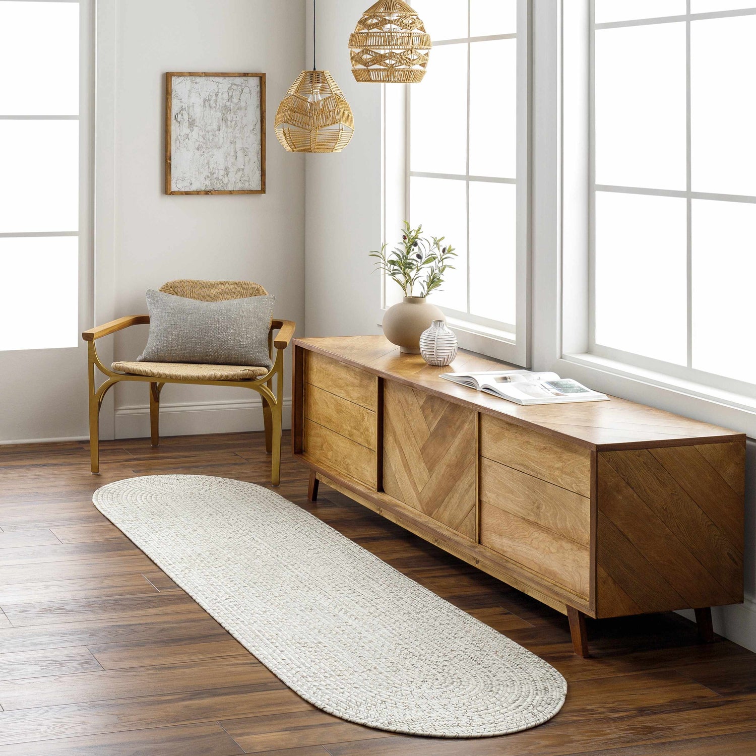 Entryway with a Beige Braided Faux Jute Rug, wood console table, woven pendant lights, and a chair with a gray pillow. Roomscene-Runner