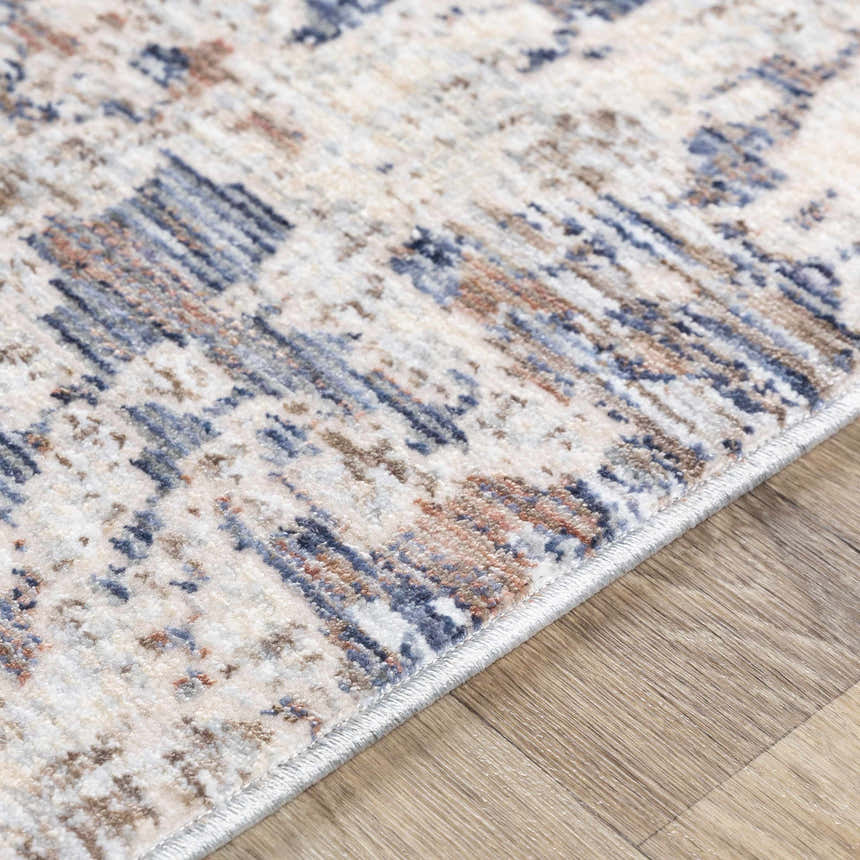 Close-up of the Broxbourne Area Rug showing a contemporary design in blush, brown, cream, and navy colors. Texture