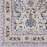 Close-up of Barrie Area Carpet showing traditional floral pattern in brown, charcoal, cream, and blue on a light beige background. Swatch