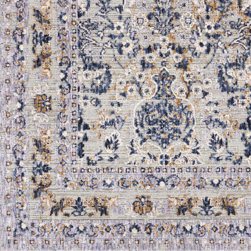 Close-up of Barrie Area Carpet showing traditional floral pattern in brown, charcoal, cream, and blue on a light beige background. Swatch