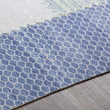 Close up of the Bishopstoke Carpet showing a blue and cream honeycomb pattern. Texture
