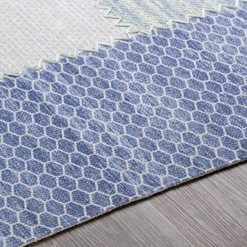 Close up of the Bishopstoke Carpet showing a blue and cream honeycomb pattern. Texture