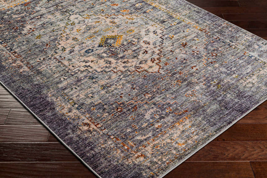 Close-up of Basiad Washable Area Rug showing traditional oriental design, blush, gray, purple, and mustard colors. Corner