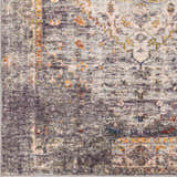 Close-up of Basiad Washable Area Rug showing traditional design, gray, oatmeal, mustard, and dark purple colors. Polyester texture. Swatch