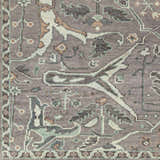 Close-up of the hand-knotted Bugasan Area Rug. Plum, tan, teal, and gray tones in a traditional Oriental pattern. 100% wool texture. Swatch