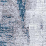 Close-up of the Bugho Area Rug, a contemporary rug in cream, gray, and teal with a distressed abstract pattern. Swatch