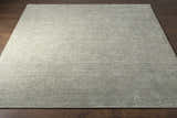 Close-up of the Bumpass Area Rug, a hand-knotted wool rug in light sage and medium gray with a subtle geometric pattern. Front