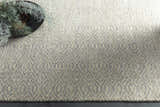 Close up of the Bumpass Area Rug. Light sage and medium gray wool rug with a geometric diamond pattern. Styleshot