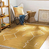 Living room scene with a mustard yellow Bushra Area Rug featuring a white geometric design. Roomscene-Rectangle
