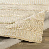 Close-up of the hand woven Bywong Area Rug. Beige and off-white jute rug with a farmhouse, traditional, transitional style. Fold
