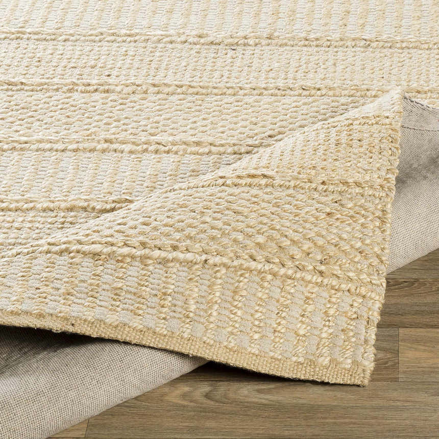 Close-up of the hand woven Bywong Area Rug. Beige and off-white jute rug with a farmhouse, traditional, transitional style. Fold