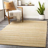 Living room scene with a beige Bywong Area Rug, jute texture, neutral chair, and plant for a farmhouse style. Roomscene-Rectangle