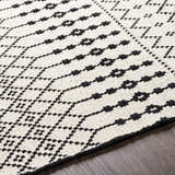 Close up of the hand woven Cabinuangan Area Carpet. Beige and black Southwestern style cotton rug. Texture
