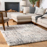 Living room scene with a cream sectional and the Calsib Area Rug in black, cream, light beige, and light gray. Roomscene-Rectangle