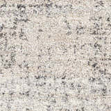 Close-up of the Calsib Area Rug. Shag rug in cream and light beige with a black and light gray abstract design. Swatch