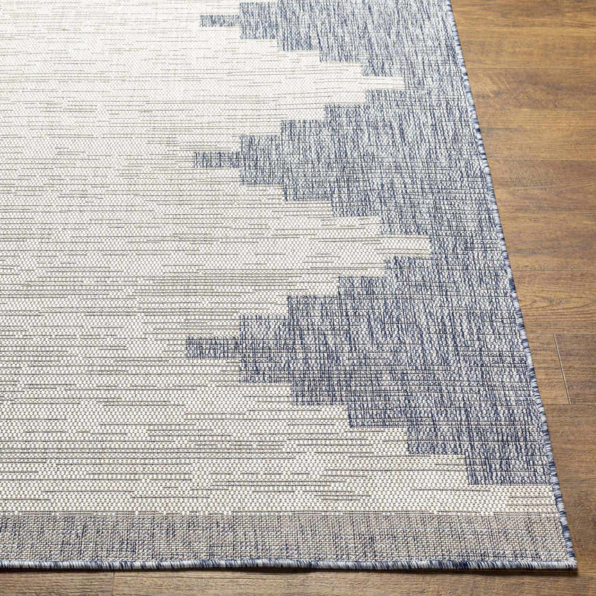 Close up of the Djugun Blue Outdoor Rug showing its geometric pattern and woven texture. Front