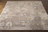 Close-up of the Cantley Handmade Wool Area Rug featuring charcoal, cream, and taupe distressed traditional pattern. Front