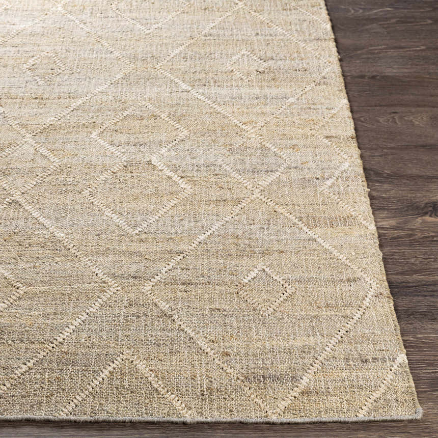 Close-up of the beige Carine Jute Area Rug showing its hand-woven texture and diamond pattern on a dark wood floor. Front