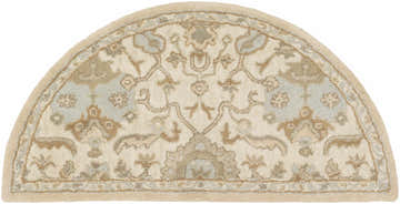 Close-up of the hearth-shaped Carrolltown Area Rug. Cream wool rug with light brown, olive, and dusty sage traditional patterns. Design-Hearth