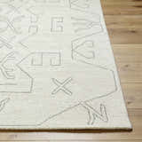Close up of the hand tufted Celia Area Rug. Cream wool rug with gray geometric pattern. Front