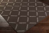 Close-up of the Charty Hand Woven Area Carpet, a dark brown wool rug with an off-white geometric square pattern. Corner