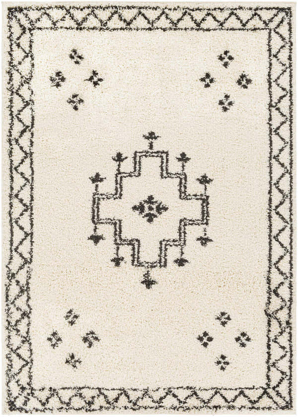 Close-up of the Cheam Area Rug. Cream shag rug with black bohemian-inspired geometric patterns and border. Design-Rectangle-537