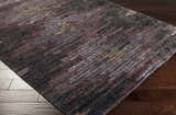Close-up of the Cherokee Carpet - Clearance. Hand-knotted viscose rug with charcoal, gray, olive, lilac, and plum colors. Contemporary style. Corner