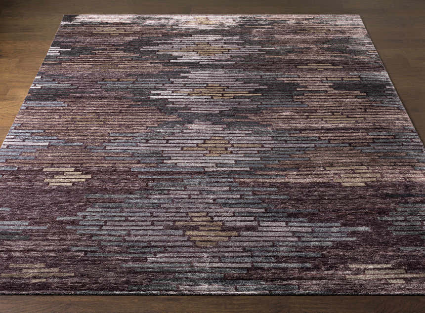 Close-up of the Cherokee Carpet. Hand-knotted viscose rug with charcoal, gray, olive, lilac, and plum hues. Contemporary style. Front