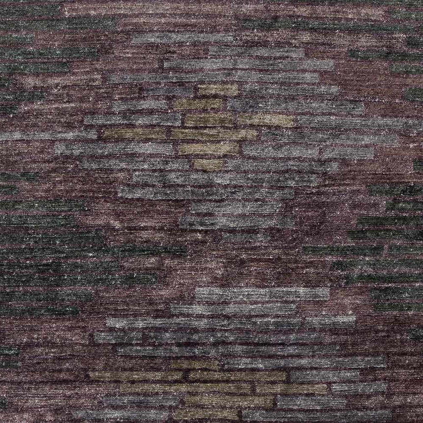 Close-up of the Cherokee Carpet, a hand-knotted rug in charcoal, gray, olive, lilac, and plum hues with a contemporary pattern. Swatch