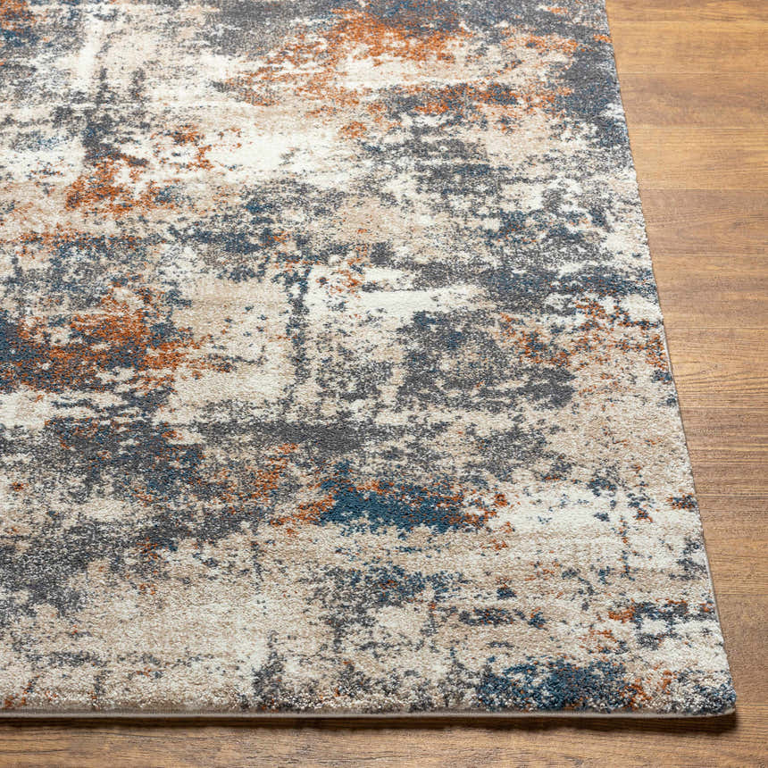 Close-up of Chetwynd Abstract Thick Rug showing blue, brown, cream, and gray abstract pattern and textured polypropylene pile. Front