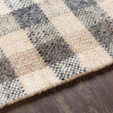 Close-up of the Chilliwack Gray Plaid Wool Rug showing charcoal, cream, gray, and tan tones and hand-woven texture. Texture
