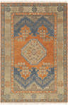 Close-up of the hand-knotted Charmhaven Area Rug. Features blue, brown, and burnt orange traditional Southwestern patterns. Design-Rectangle-69
