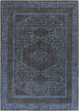Close-up of the Chesham Clearance Rug. Hand-knotted wool rug in charcoal, dark blue, and teal with a traditional geometric pattern. Design-Rectangle-811