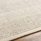 Close-up of the Cinco Luxe Rug showing its bone and gray contemporary pattern and soft, textured weave. Texture