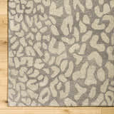 Close-up of the hand-tufted Circa Leopard Print Area Rug. Beige and beachhouse tones. 100% Wool rug with a contemporary style. Corner