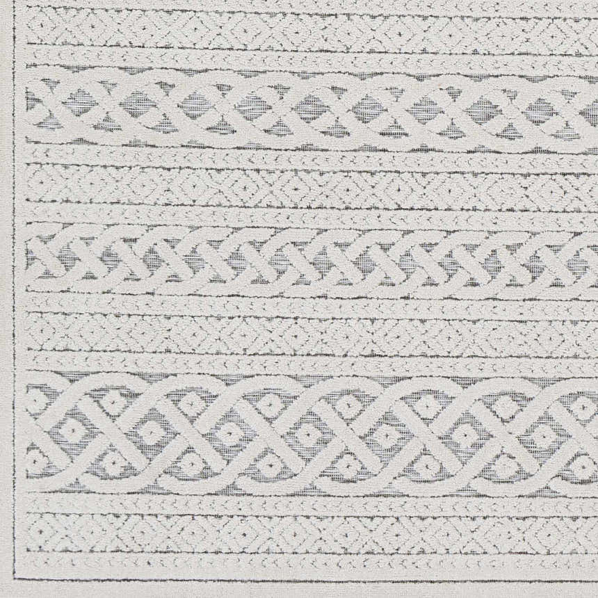 Close-up of the Clenchwarton Textured Beige Rug. Features light beige and charcoal geometric patterns and woven texture. Swatch