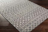 Close-up of the Cliffwood Area Rug. Charcoal and light beige geometric pattern. Contemporary style. Corner