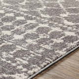 Close-up of the Cliffwood Area Rug. Charcoal, gray, and light beige abstract pattern. Machine woven texture. Texture