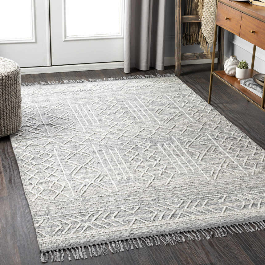 Entryway with Gray Clintwood Wool Tassel Carpet, dark wood floors, gray curtains, and wood console table. Roomscene-Rectangle