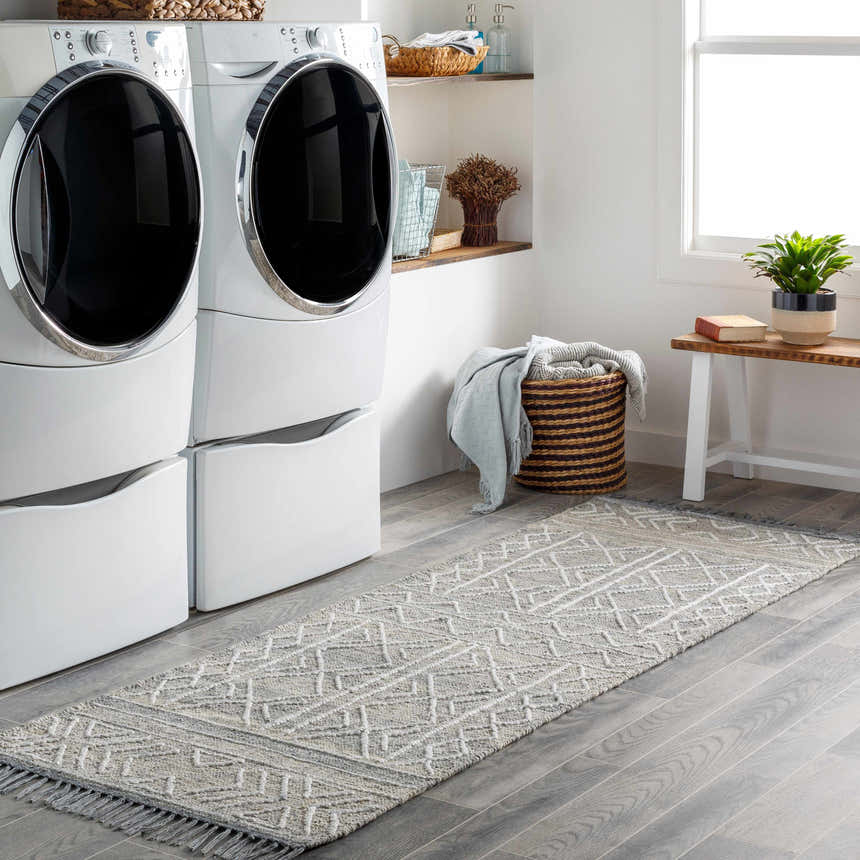 Laundry room with gray wood-look tile and Gray Clintwood Wool Tassel Carpet. White washer and dryer. Roomscene-Runner