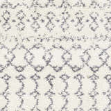 Close-up of the shag Clarkia Area Rug in white with gray geometric patterns. Bohemian style. Swatch