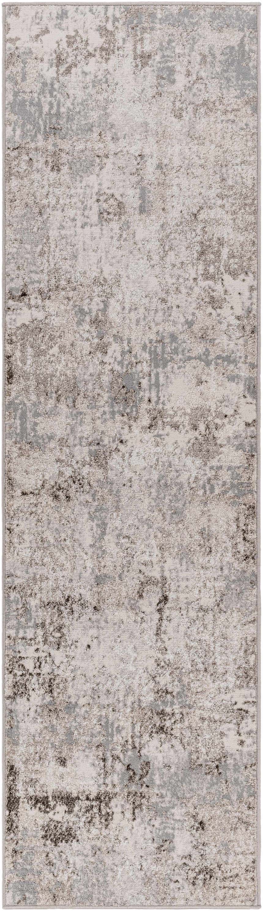 Close-up of the Calvinia Area Rug featuring a contemporary charcoal, gray, and light gray abstract design. Design-Runner
