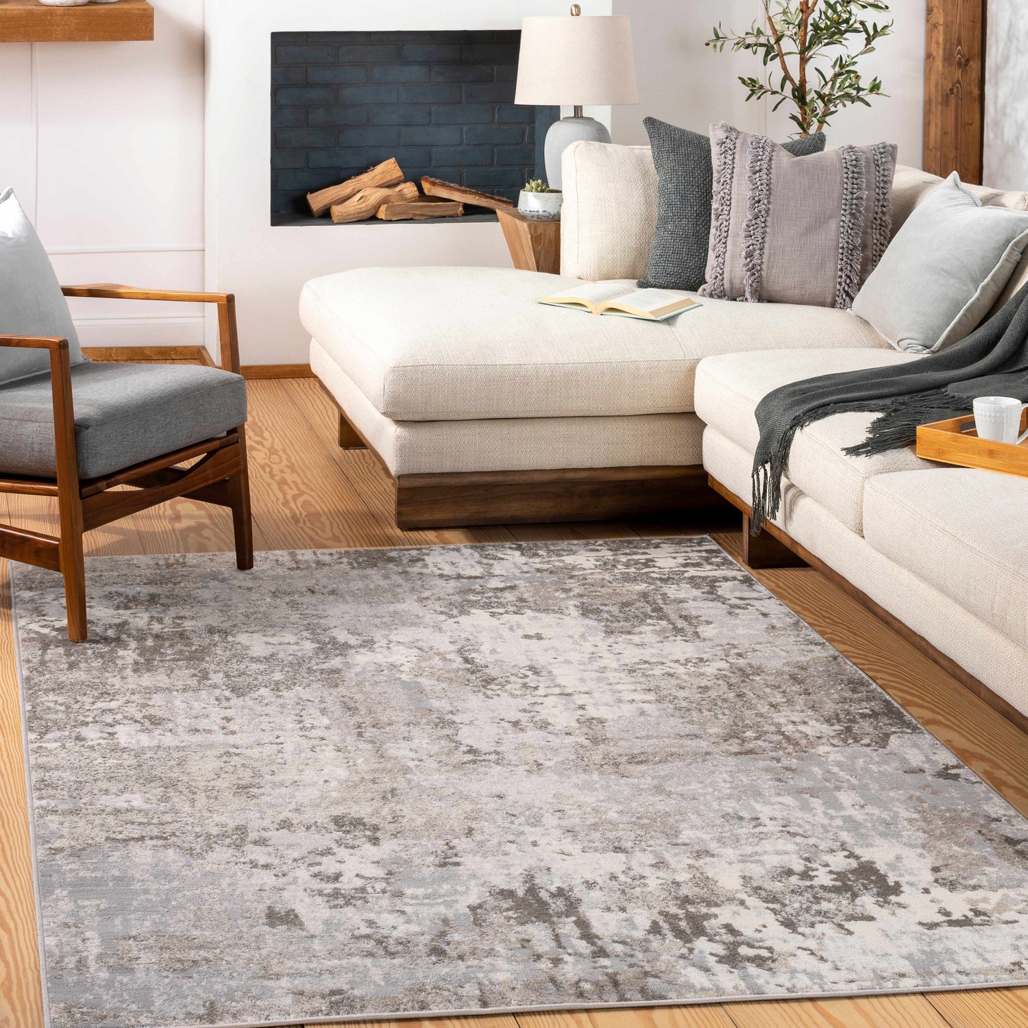 Living room scene with a charcoal, gray, and light gray Calvinia Area Rug, cream sofa, and modern fireplace. Roomscene-Rectangle