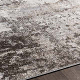 Close up of the charcoal, gray, and light gray Calvinia Area Rug. Contemporary style, machine woven texture. Texture