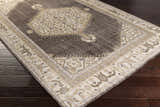 Close-up of the brown and off-white Clyo Carpet, a hand-knotted wool rug with a traditional design. Corner